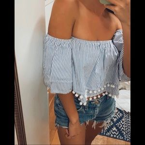 Blue and white strapless top with pom poms